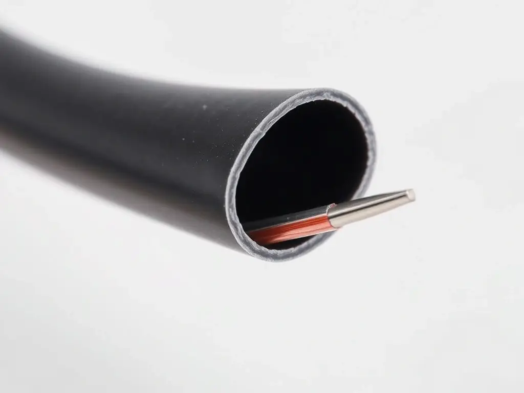 A close-up of Raychem DR-25 Alternative Heat Shrink Tubing, showcasing its flexibility and durability in a high-temperature environment, with a focus on its smooth surface and precise cut edges.